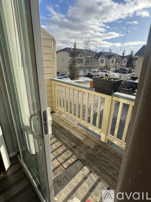 A balcony with a view of a snowy landscape and houses.