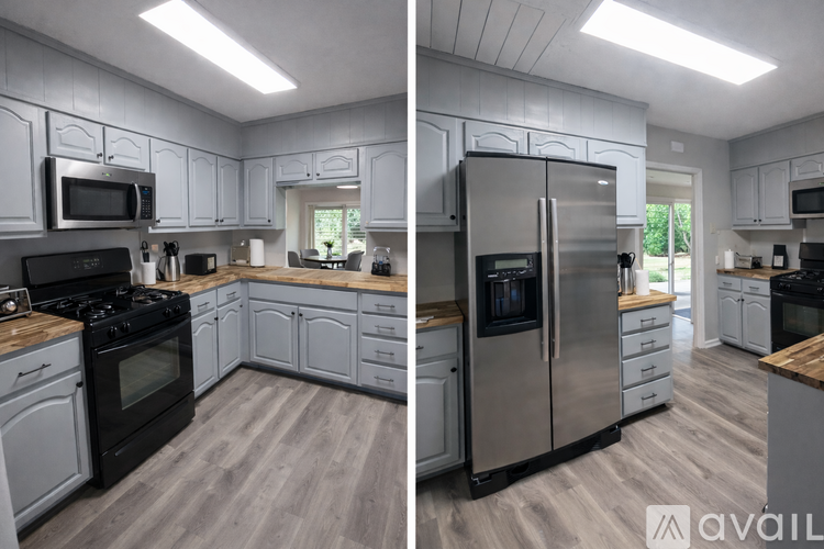 A modern kitchen with stainless steel appliances and wooden floors.