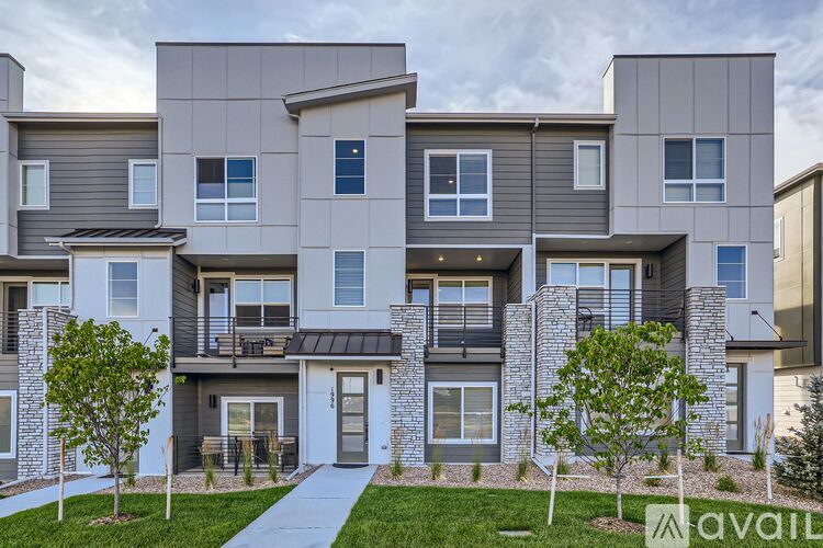 A modern apartment building with a walkway in front.