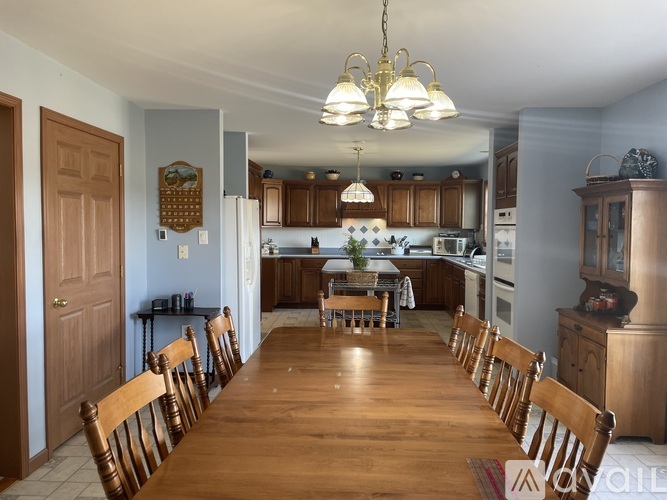 A kitchen with a table and chairs in the middle of the room.
