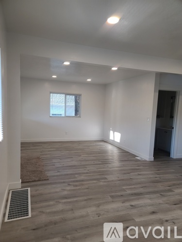 A room with wooden flooring and a window is available for rent.