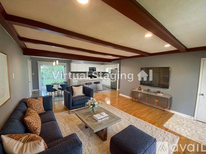 A living room with a sofa, armchairs, and a coffee table.