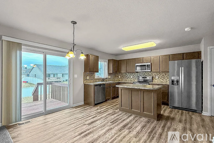 A kitchen with wooden cabinets and a refrigerator.