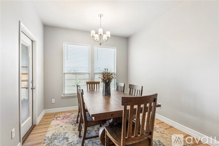 A dining room with a wooden table and chairs.