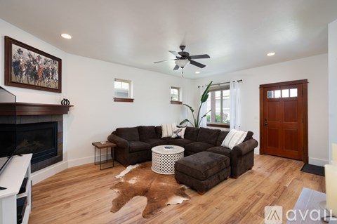 A living room with a fireplace and a painting on the wall.
