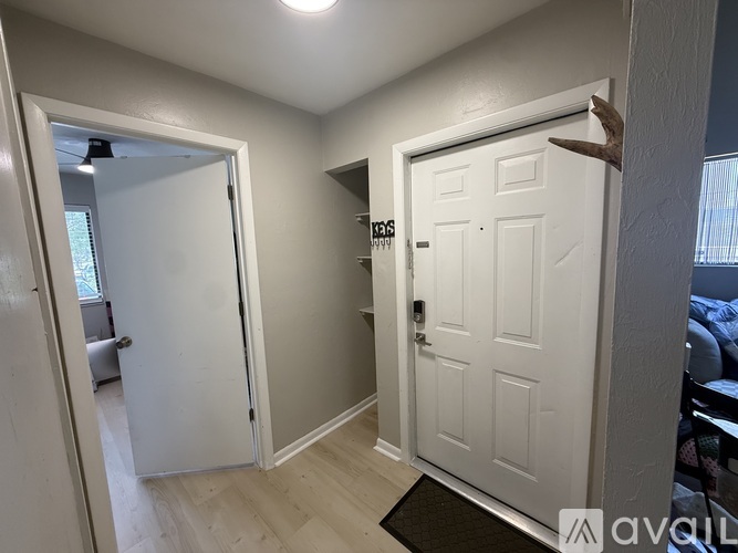 A white door with a black handle is in a room with a light on the ceiling.