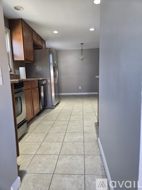 A kitchen with a refrigerator, oven, and microwave.
