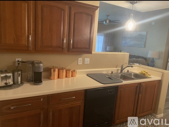 A kitchen with wooden cabinets and a white countertop.