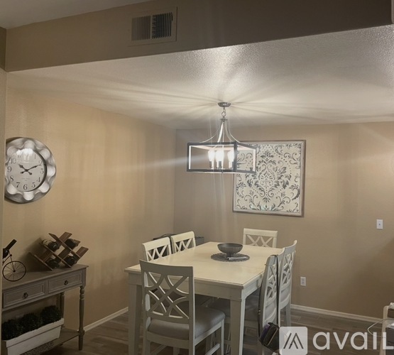 A dining room with a table set for four.