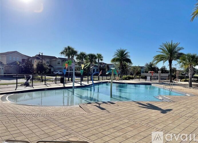 A sunny day at the outdoor pool with palm trees.