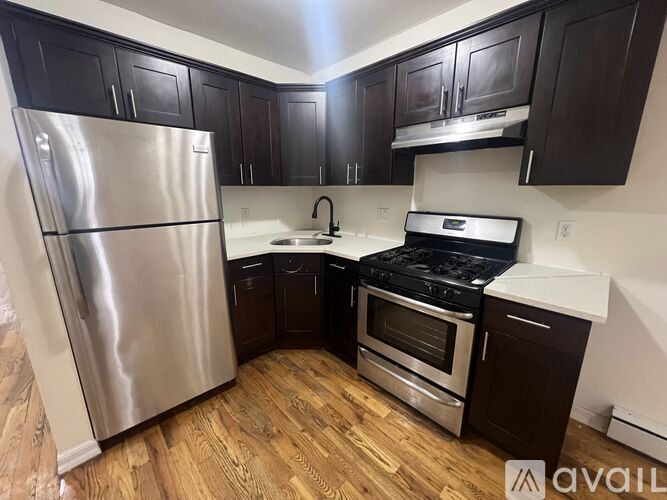 A kitchen with a stainless steel refrigerator, stove, and oven.