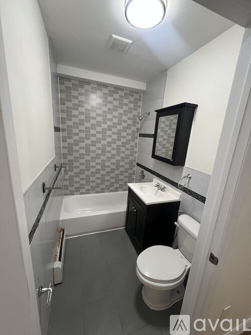 A small bathroom with a toilet, sink, and bathtub.