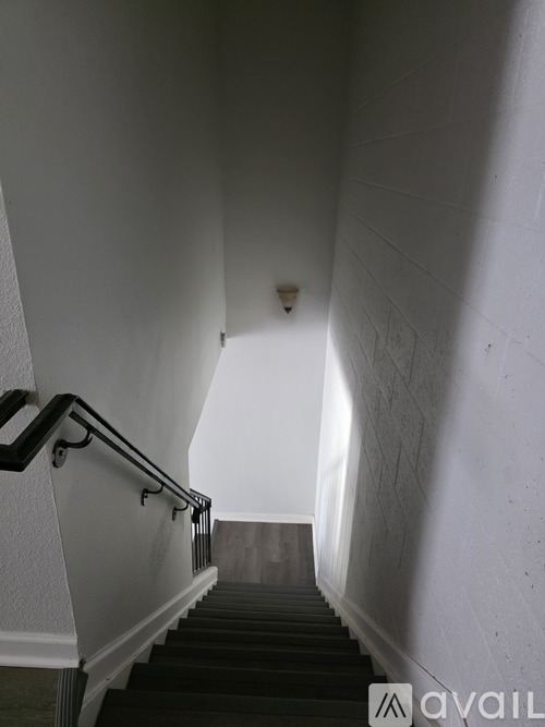 A staircase with a metal handrail and wooden steps.