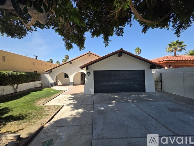 A house with a garage and a driveway is available for sale.