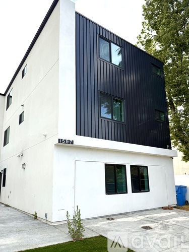 A modern two-story building with black and white exterior.