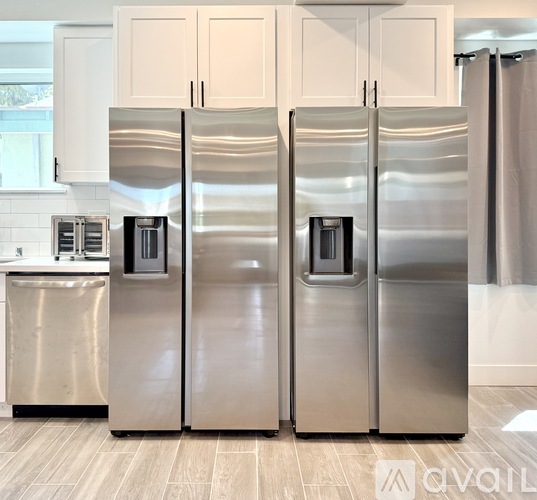A stainless steel refrigerator in a kitchen.