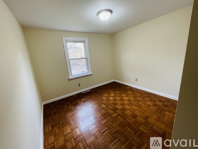 A room with a wooden floor and a window.