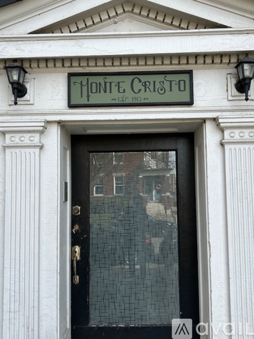 The Monte Cristo restaurant has a black door with a glass window.
