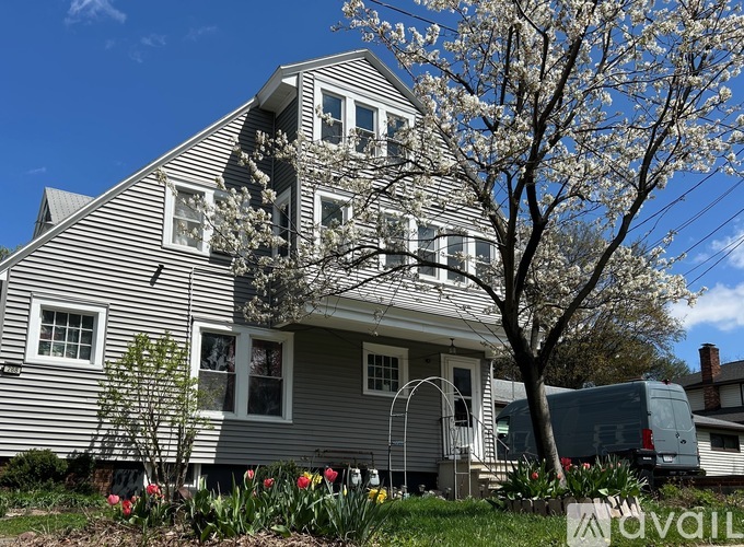 A house with a tree in front of it.