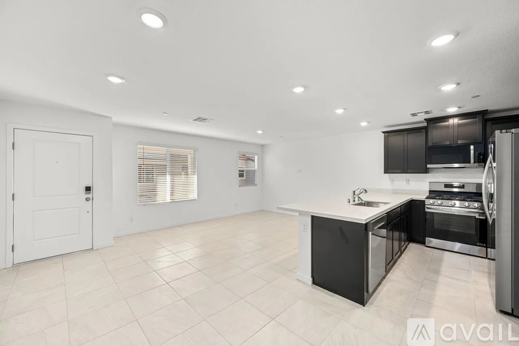 A modern kitchen with a large island and stainless steel appliances.