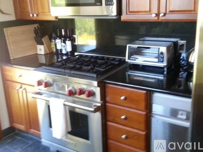 A kitchen with a stove top oven and a toaster oven.