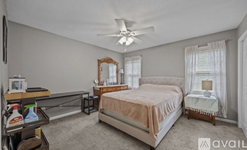 A bedroom with a large bed and a vanity table.
