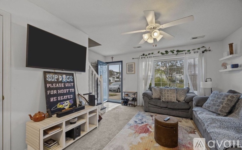 A living room with a sign that says "SUPERMARKETS PLEASE WAIT FOR HOST TO BE SEATED".
