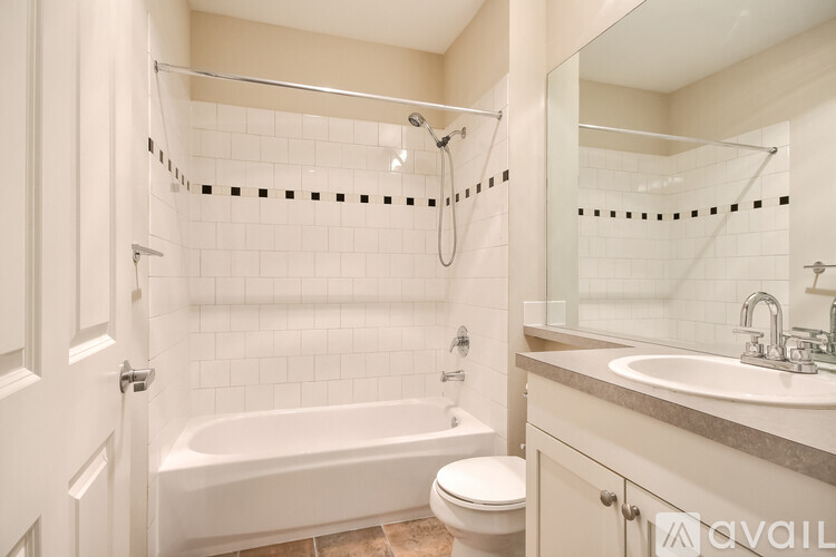 A bathroom with a white tub, toilet, and sink.
