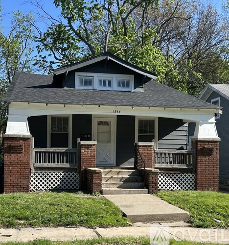 A house with a grey front porch and a white door.