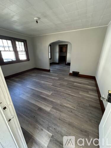 A room with wooden flooring and a white ceiling.