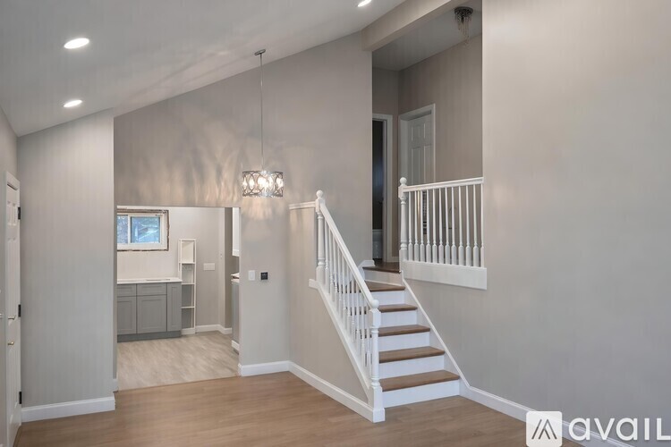 A spacious interior of a house with a staircase leading to the second floor.