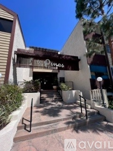 The entrance to a place called Pines is shown.