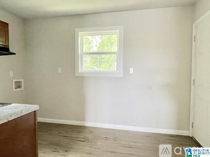 A room with a window and a counter.