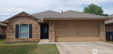 A two-car garage is attached to a brick house.