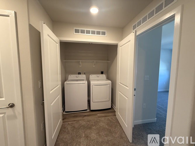 A bathroom with a glass shower door and a sink with a countertop.