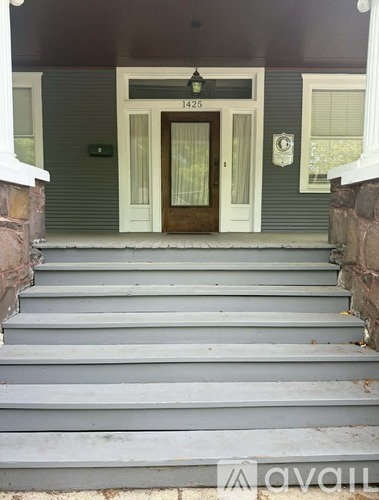 Steps leading to a door with a number 1425 above it.