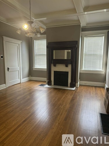 A room with a fireplace and wooden floors.