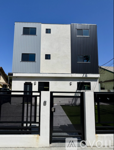 A modern two-story building with a black and white exterior.