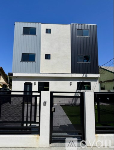 A modern two-story building with a black and white exterior.