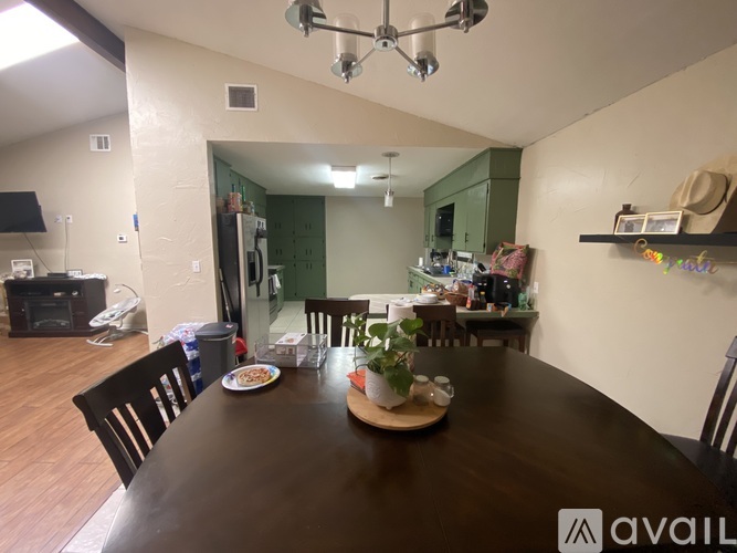 A dining room with a wooden table and chairs.