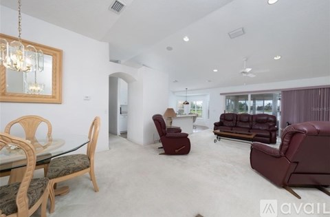 A living room with a glass table and chairs.