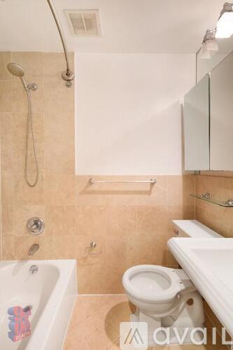 A bathroom with a toilet, sink, and shower.