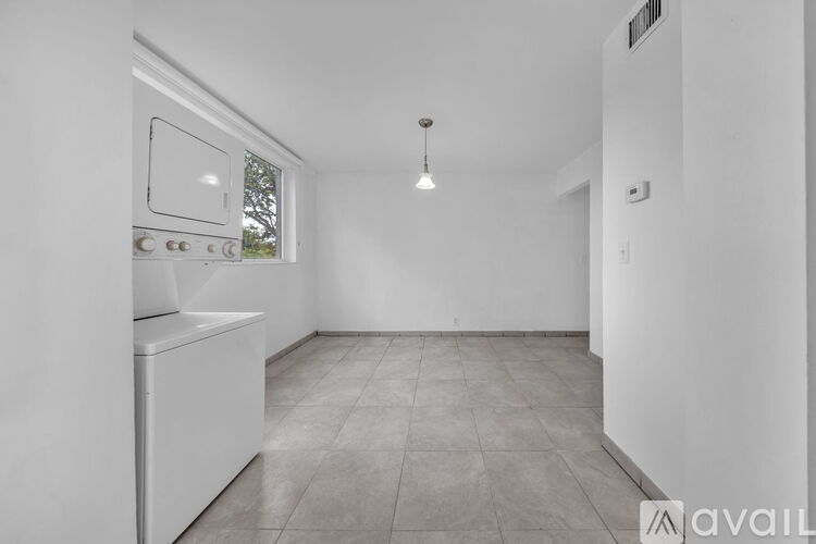 A kitchen with a white oven and a window.