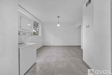 A kitchen with a white oven and a window.