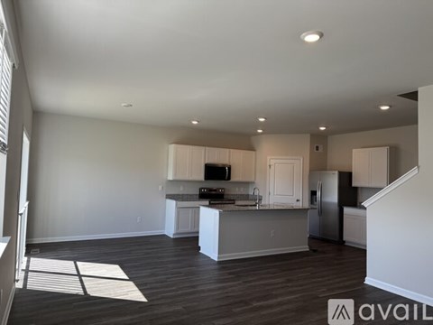 A spacious kitchen with white cabinets and a central island.