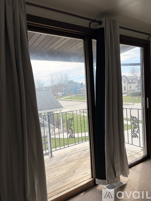 A balcony with a view of a residential area.