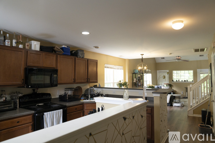 A kitchen with wooden cabinets and a white countertop.