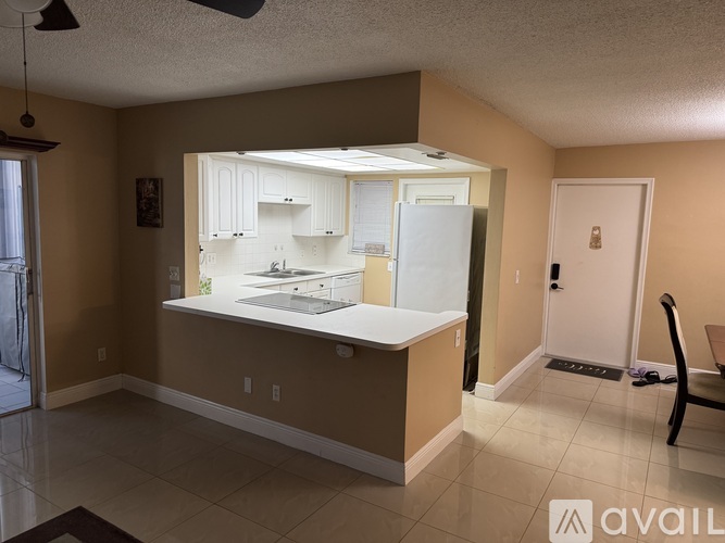 A kitchen with brown walls and white appliances.