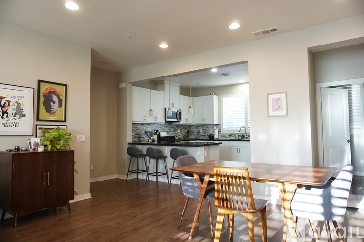 A dining room with a wooden table and chairs.
