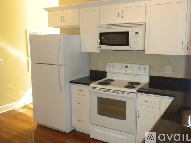 A white refrigerator and oven in a kitchen.
